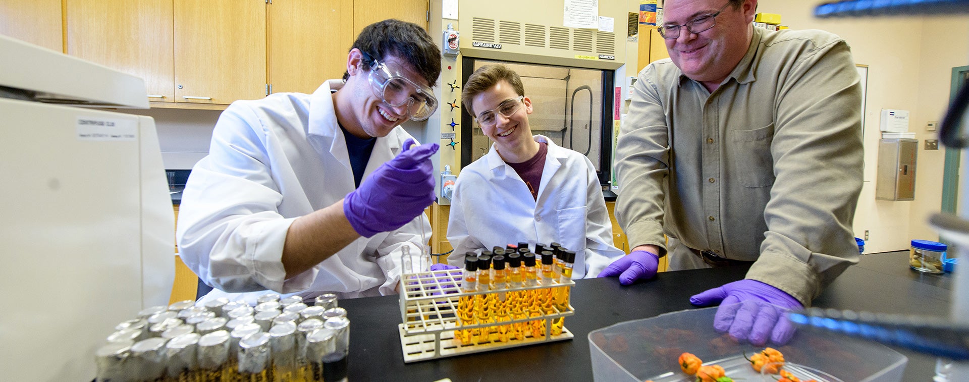 photo of Dr Cahill at research lab with students