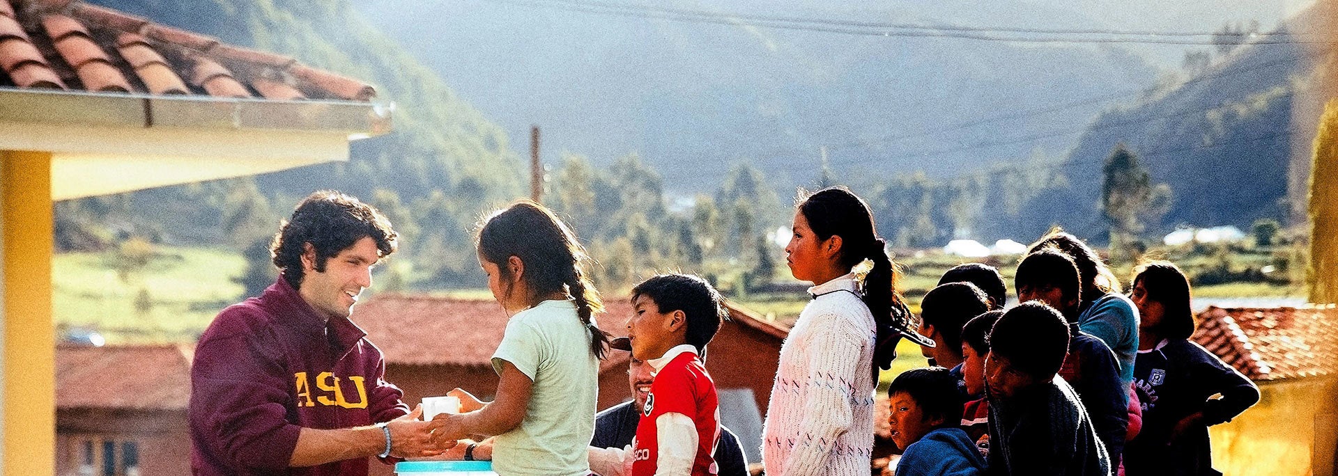 photo of student in peru handing out water