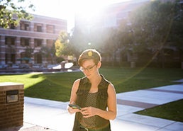 photo of student holding phone in hand