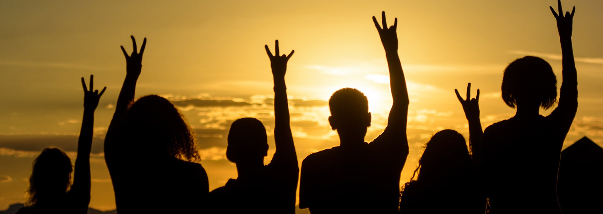 photo of student shadows at sunset holding pitchfork hands