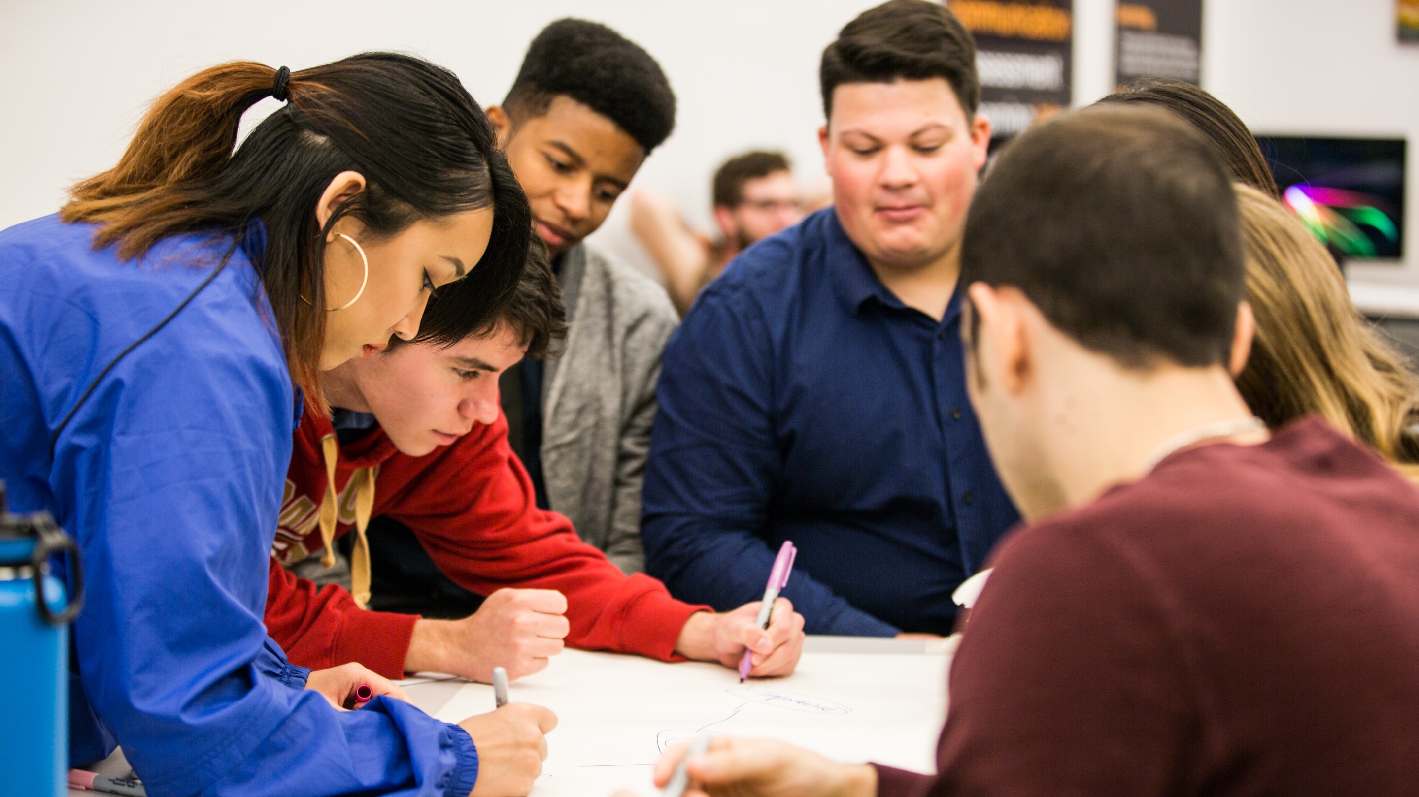 Individuals working together in an academic setting.