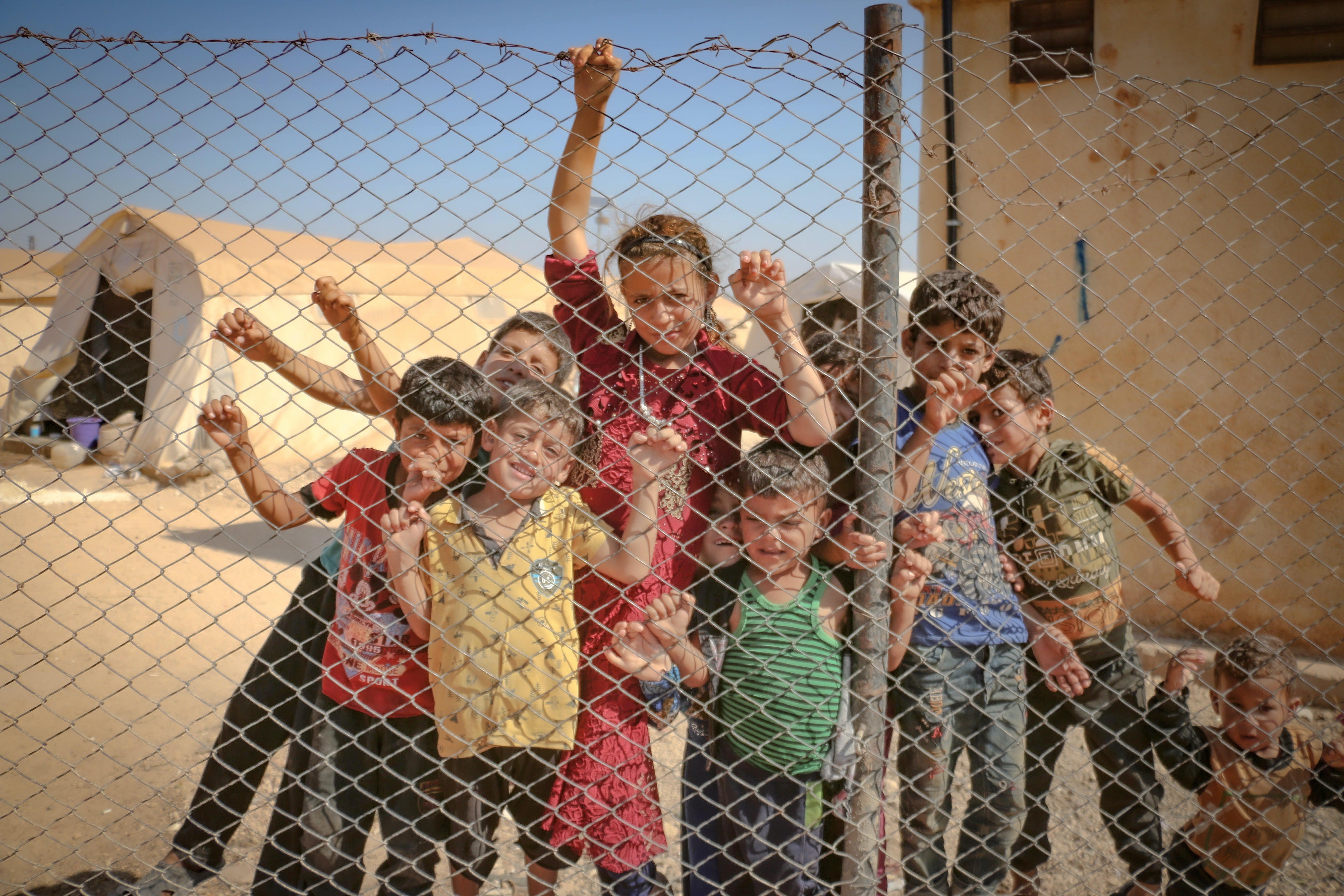 Children sitting in a refugee camp in Idlib, Idlib Governorate, Syria
