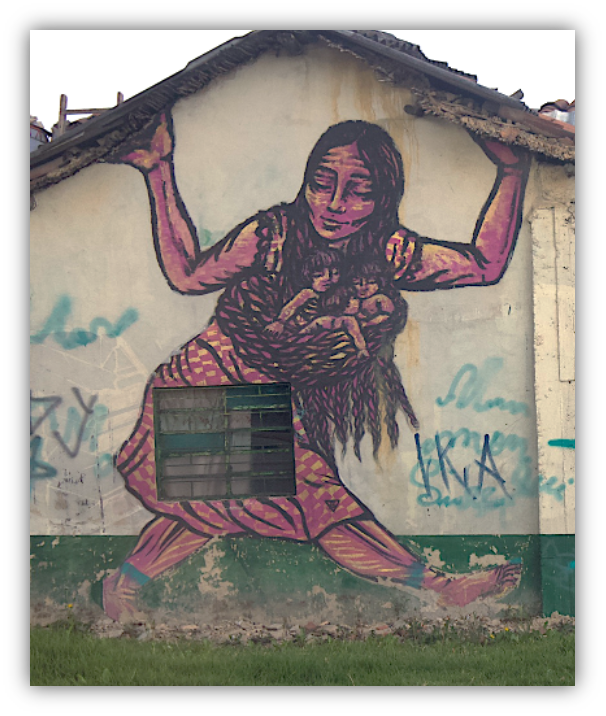 Art on the side of a house depicting a woman