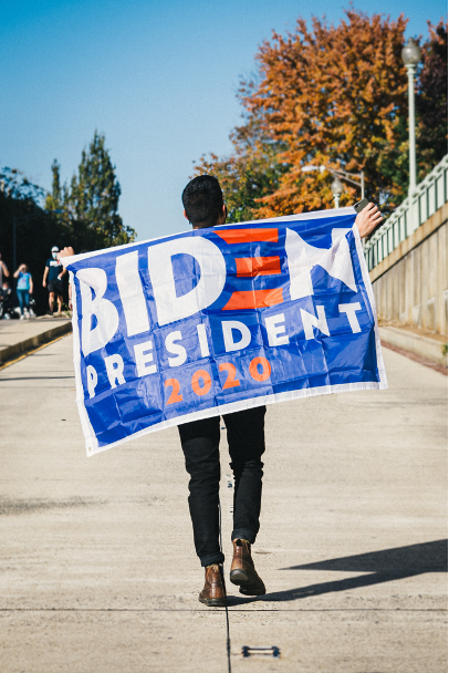 Man holding a Biden 2020 flag