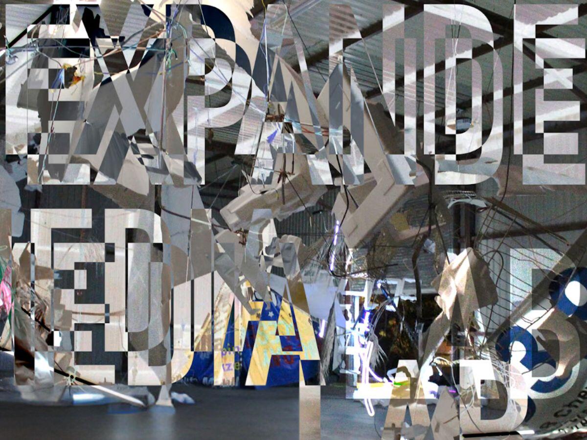 Abstract sculpture with overlay text "EXPANDED MEDIA LAB."