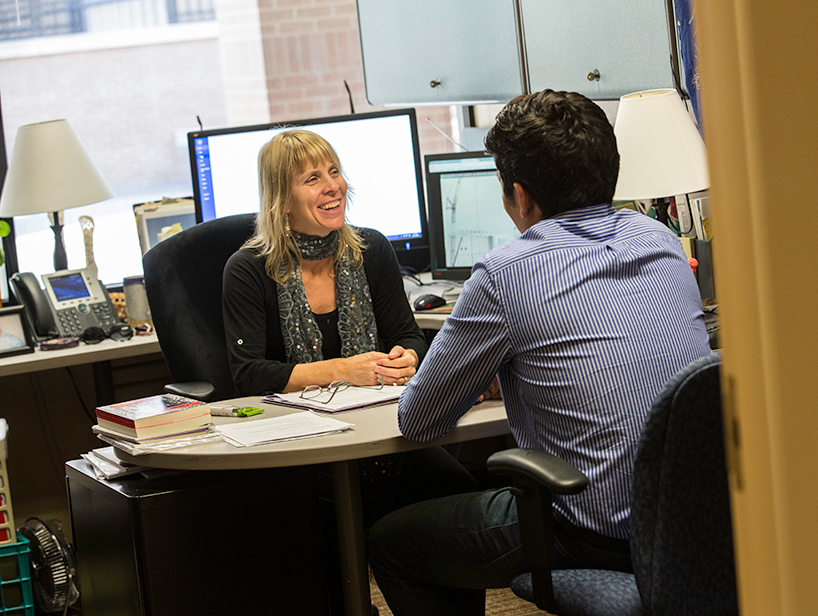 photo of Dr. Nadesan meeting with student in her office