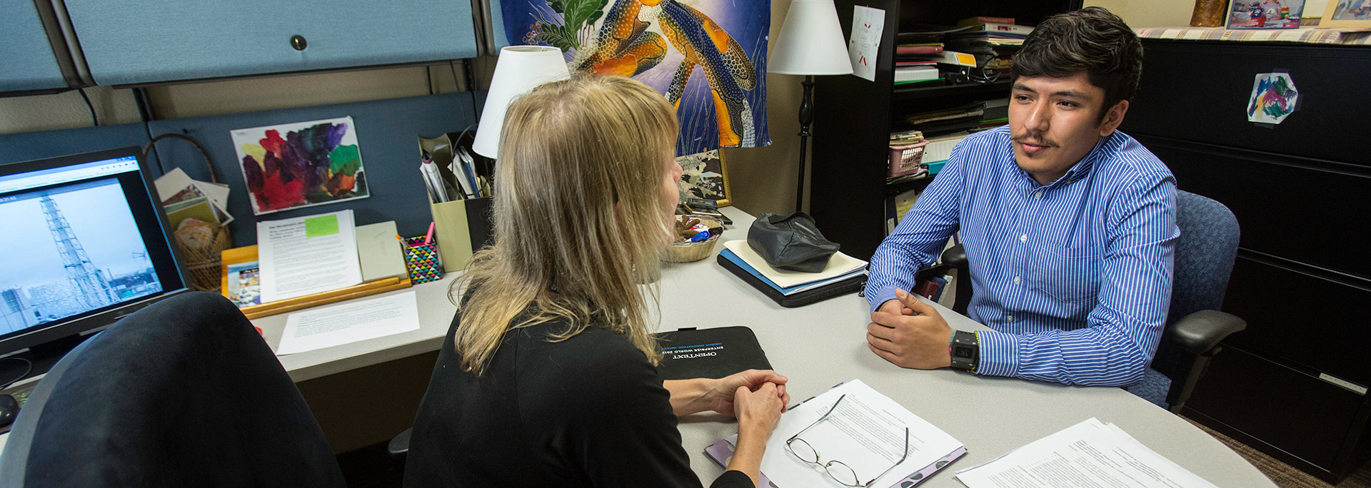 photo of student meeting with faculty during office hours