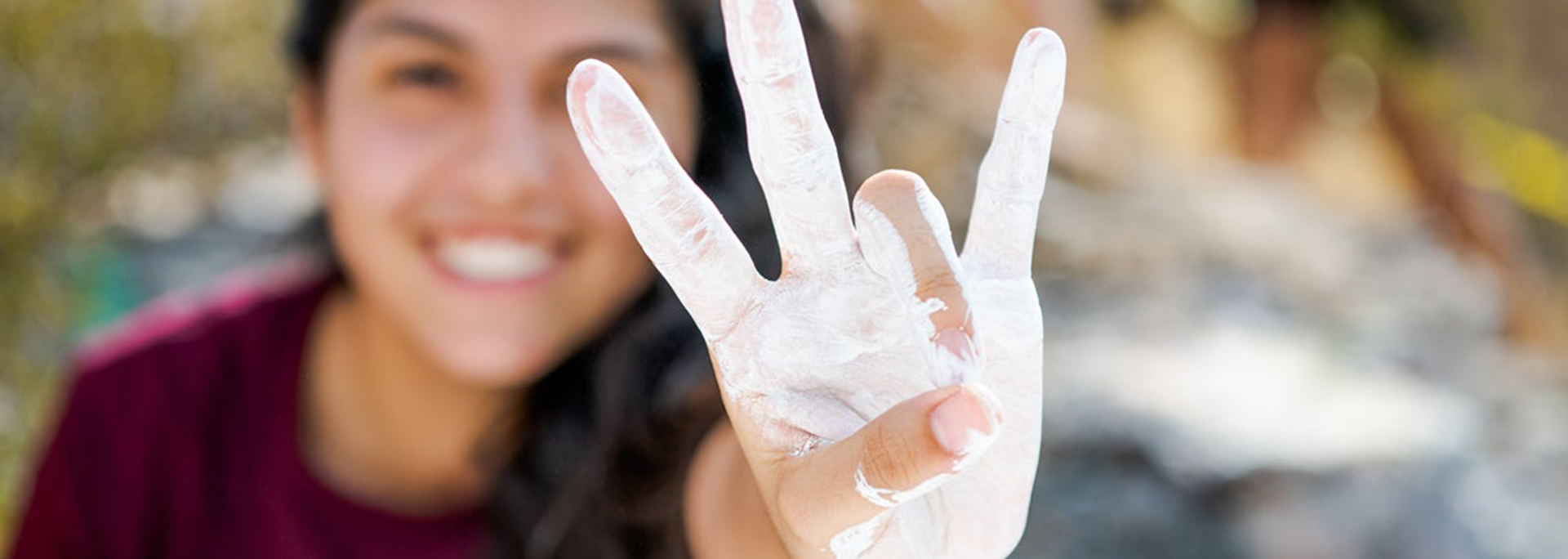 photo of student making pitchfork hand with A mountain paint