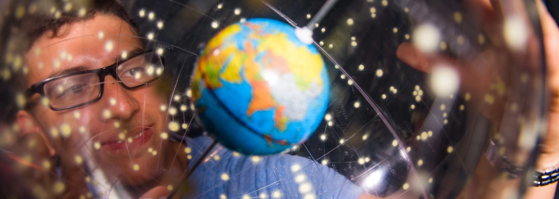 photo of student with globe 