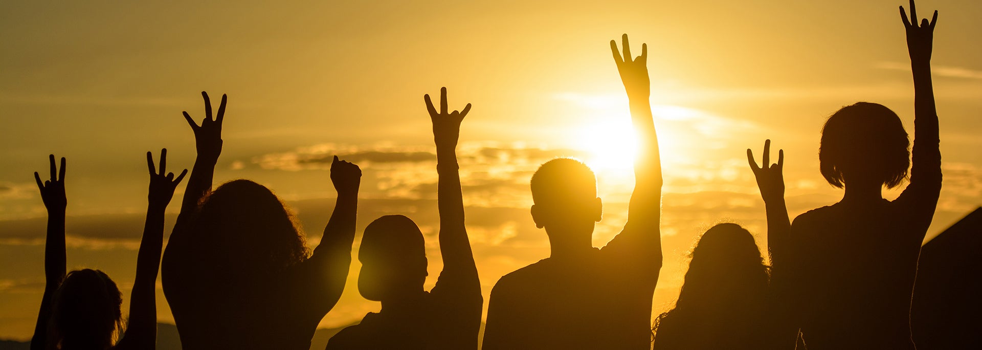 photo of students raising hands making pitchforks