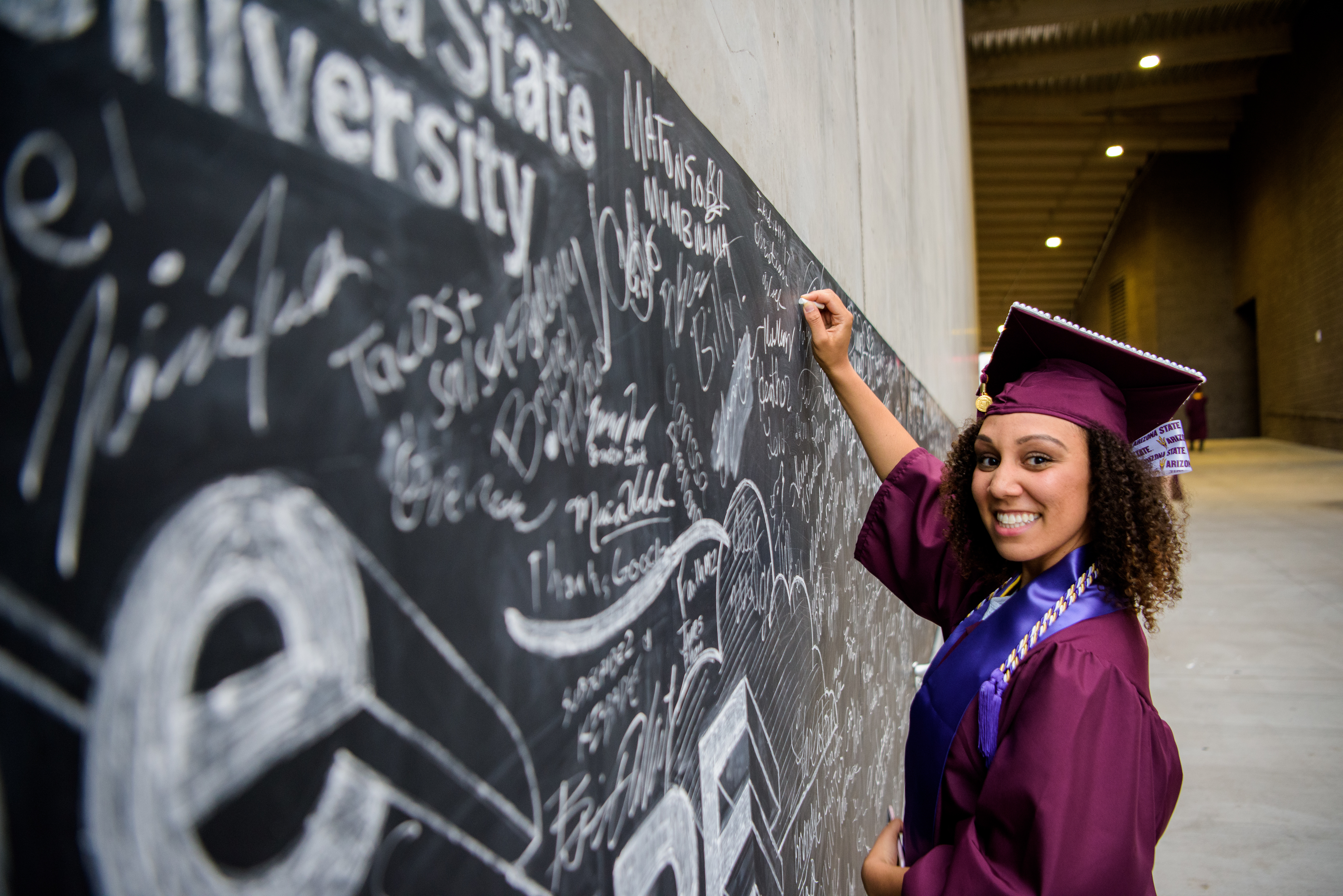 ASU graduate poses at convocation ceremony