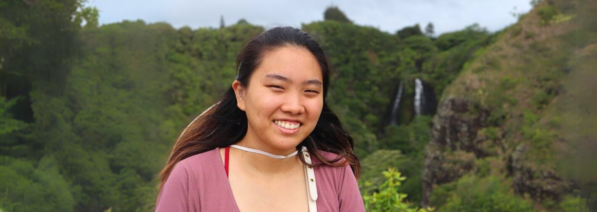 Tiffany Kawamura standing in front of a large green forest