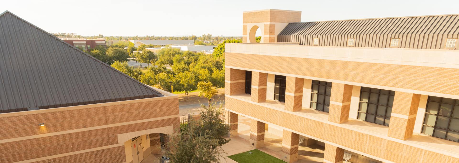 two brick buildings on the West Valley campus illuminated by the sun
