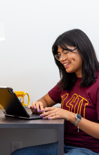 Student working on tablet in dorm room