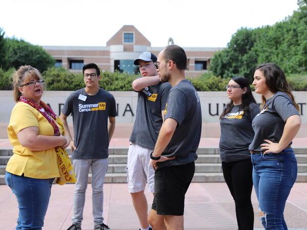 A group of students being instructed outside